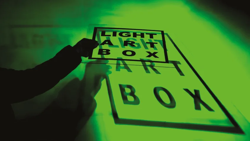 Light Art Box lettering revealed with a stencil and light